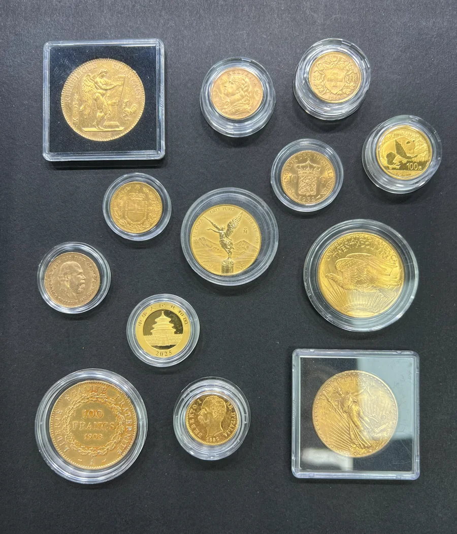 A selection of collectible gold coins retained in protective capsules