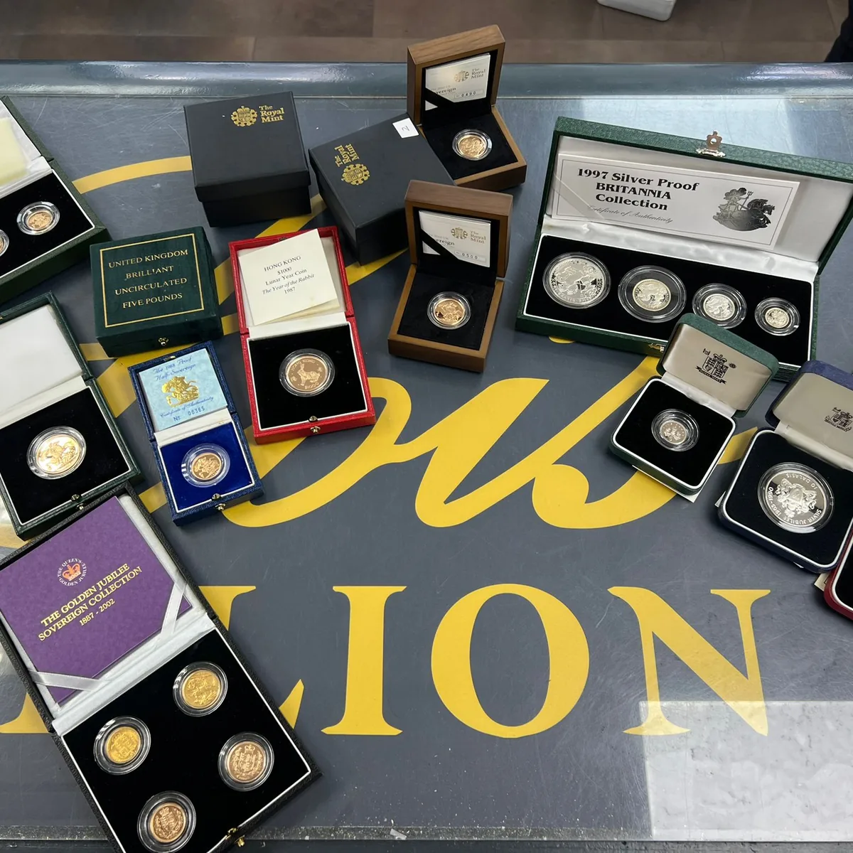 A mixed collection of gold and silver proof coins in their original presentation cases