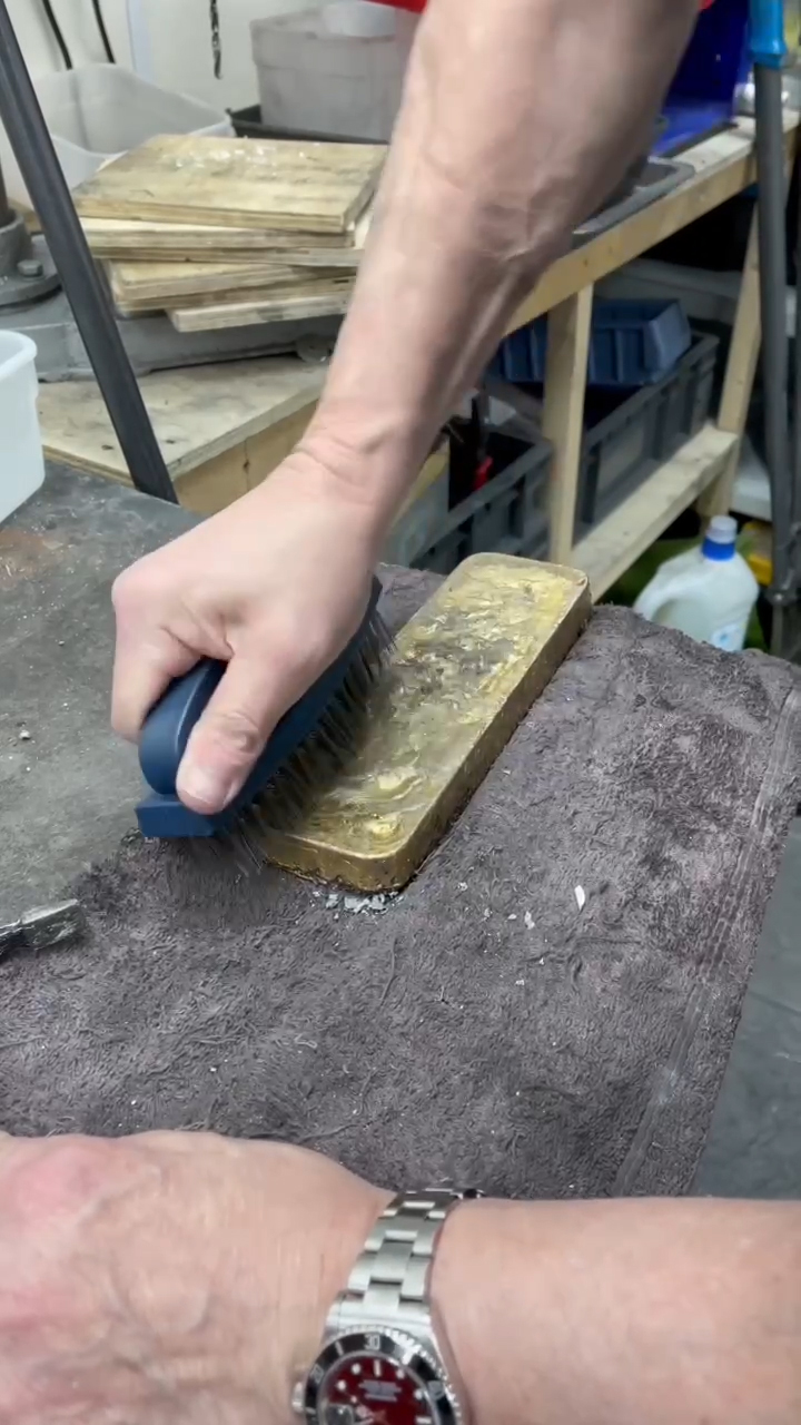 Cleaning the gold bar with a cloth and brush